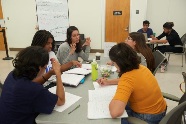 Students working together on a group project in a discussion