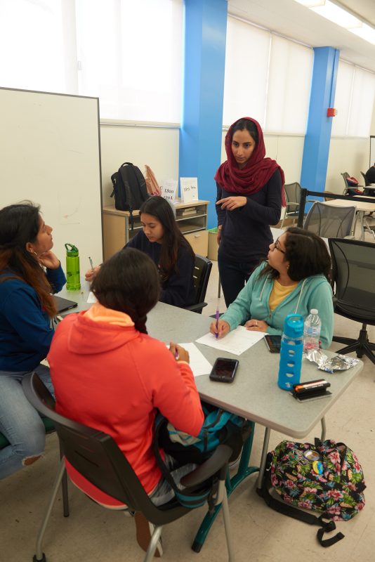 Instructor talking to a group of students