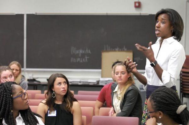 Dean Tracy Johnson lecturing to a group of students in a classroom